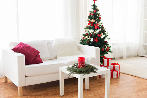 istock sofa, table and christmas tree with gifts at home 497681688