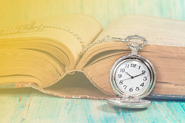 istock vintage pocket clock and old books 497681786