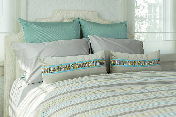 istock cozy bedroom interior with white pillows and reading lamp 497682126