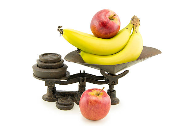 Antique Kitchen Scale Set with Apples and Bananas An old fashioned antique kitchen scale set featuring apples and bananas on a plain white background vintage kitchen scale with fruit stock pictures, royalty-free photos & images