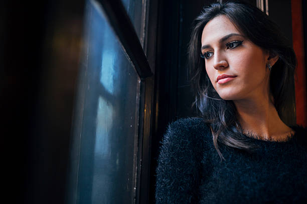 istock Pretty woman looking out the window 497683426