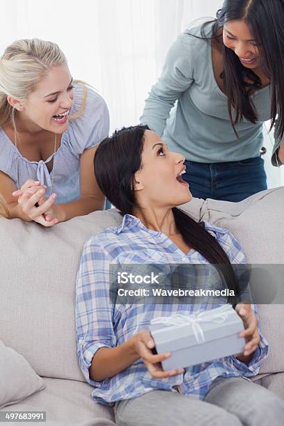 Friends Surprising Brunette With A Present Stock Photo - Download Image Now - 20-29 Years, Adult, Apartment