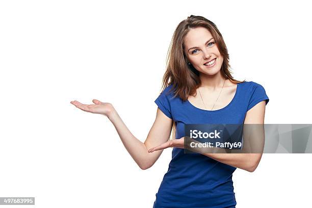 Smiling Woman Showing Copy Space Stock Photo - Download Image Now - Women, Pointing, Teenage Girls