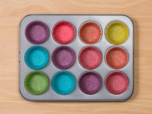 istock muffins baking tray with colourful paper cases 497684112