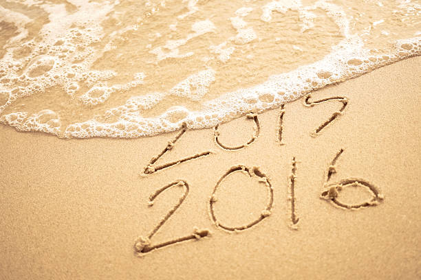 istock Year 2016 text on the beach for new year concept background 497684748