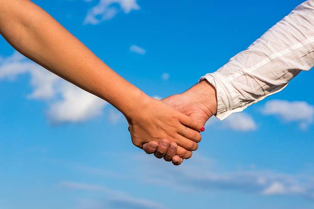 istock Two pairs of hands in love 497686820