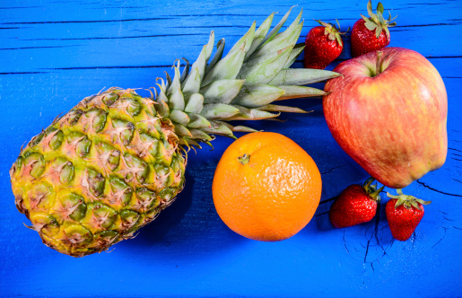 Selection of fruit on the blue wooden plank