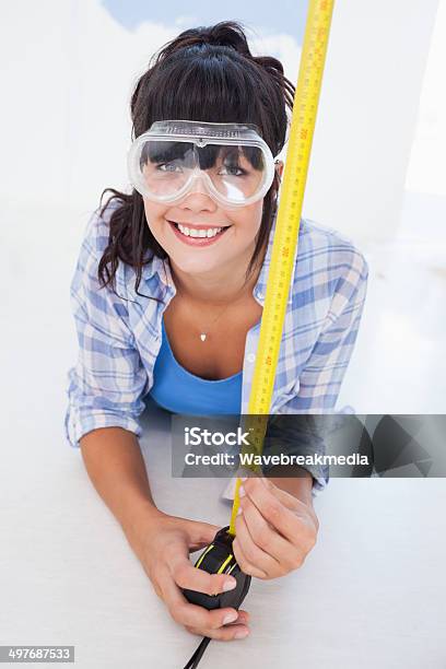 Happy Woman Lying On Floor With Measuring Tape Stock Photo - Download Image Now - 20-29 Years, Adult, Adults Only
