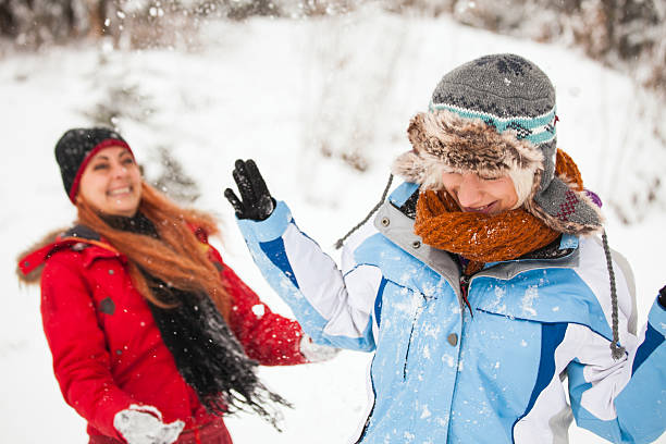 istock Female friends having fun with snow 497688120