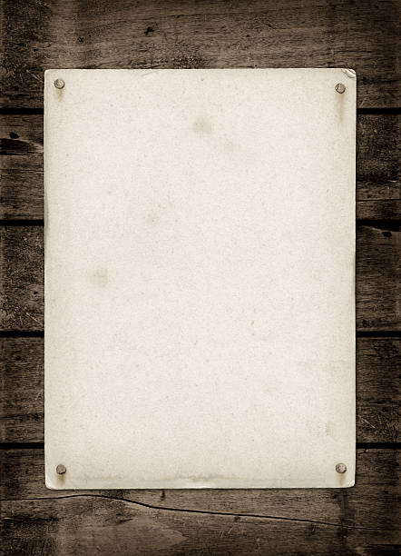 istock Old textured paper sheet on a dark wood table 497688592
