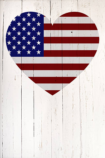 istock U.S flag in heart shape on a white wooden board 497688868