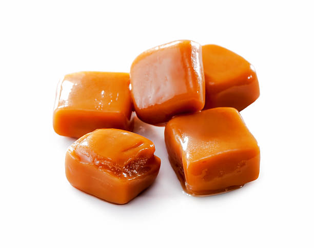 istock melted toffee caramel candy close-up isolated on white 497689114