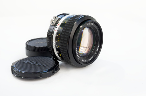 Bergen, Norway - June 15, 2014: A vintage Nikkor 50mm 1.4 (standard, manual focus) lens for Nikon 35mm single-lens reflex photography camera (with interchangeable lenses). The pictured lens was made around 1980.