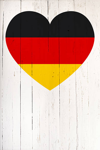 istock German flag in heart shape on a  white wooden board 497689548