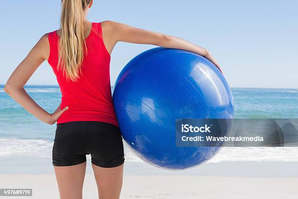 Fit Blonde Holding Exercise Ball Looking At Sea Stock Photo - Download Image Now - Fitness Ball, Sea, 20-29 Years