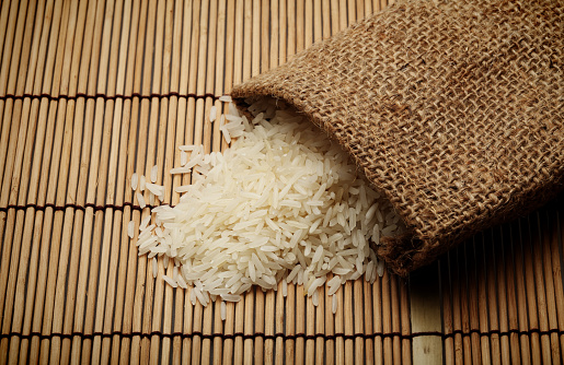 White uncooked rice in small sack 