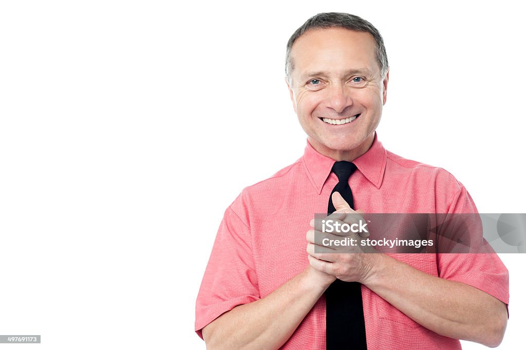 Businessman with hands clasped Confident businessman with his hands clasped Active Seniors Stock Photo