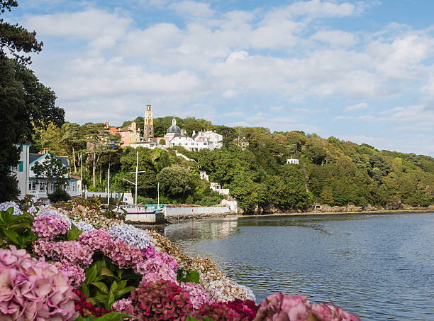 View on the town of Portmeirion View on the town of Portmeirion from the beach at the estuary of the river Dwyryd which leads into Tremadog Bay in North Wales portmeirion stock pictures, royalty-free photos & images