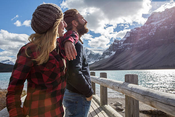 istock Cheerful couple on log bridge admiring landscape 497704362