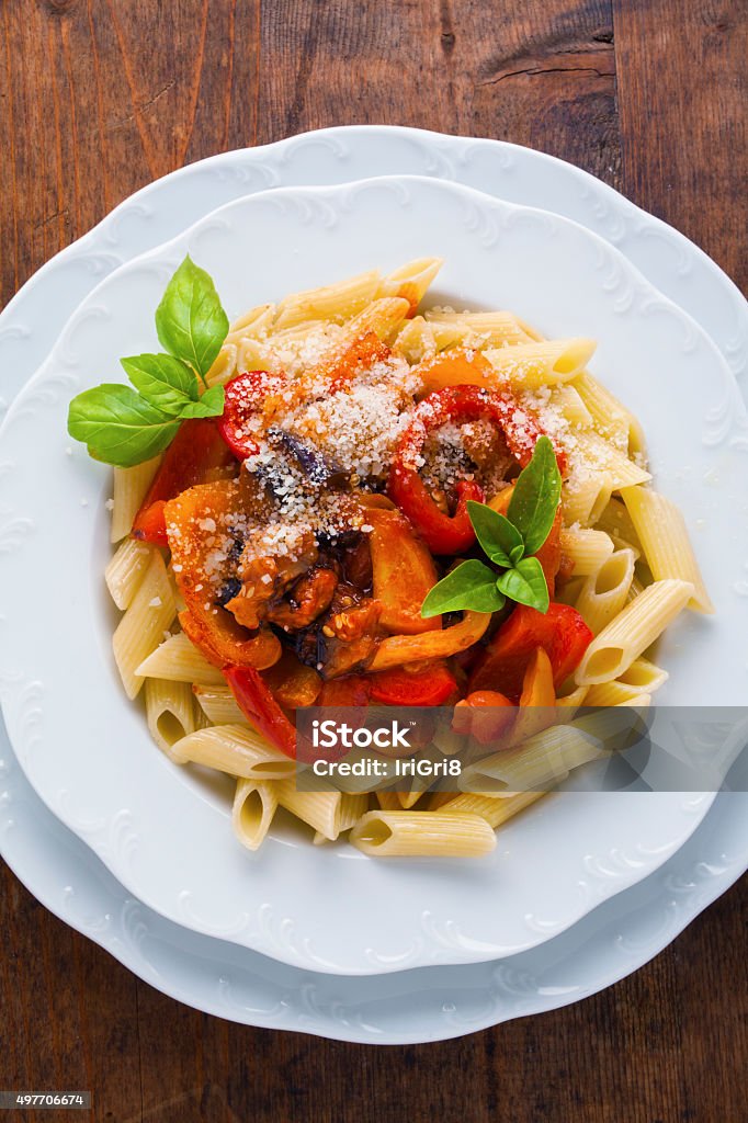 Pasta with roasted sweet Peppers and Eggplant on wooden vintage Pasta with roasted sweet Peppers and Eggplant on wooden vintage table. healthy Vegetarian pasta 2015 Stock Photo