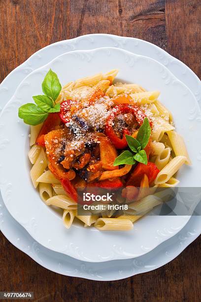 Pasta With Roasted Sweet Peppers And Eggplant On Wooden Vintage Stock Photo - Download Image Now