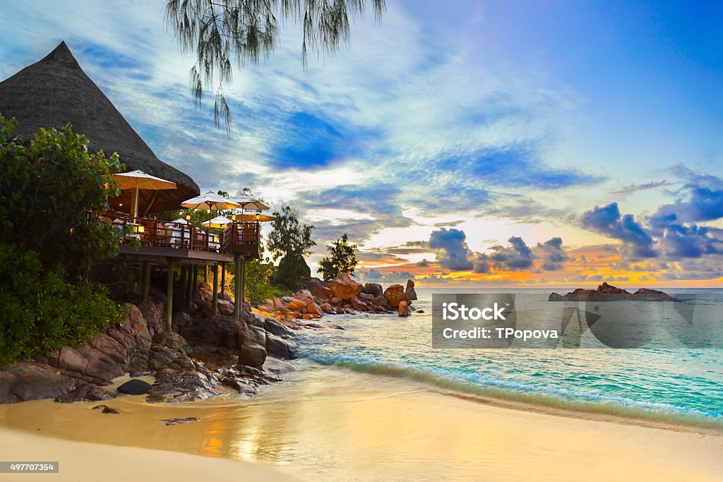 Cafe on tropical beach at sunset Cafe on tropical beach at sunset - nature background Seychelles Stock Photo