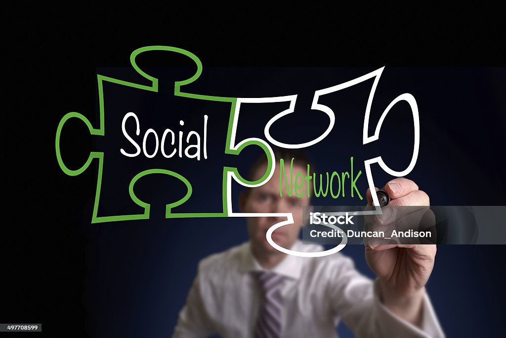 Social Network A Businessman drawing a social network puzzle concept. Adult Stock Photo