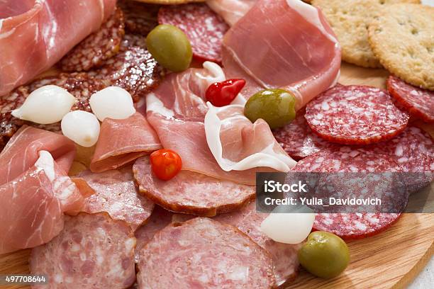 Assorted Deli Meat Snacks Sausages And Pickles On Board Stock Photo - Download Image Now