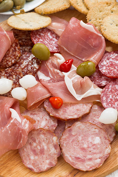 istock Assorted deli meat snacks, sausages and pickles on board 497708698