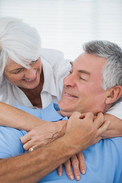 istock White haired woman hugging husband 497708805