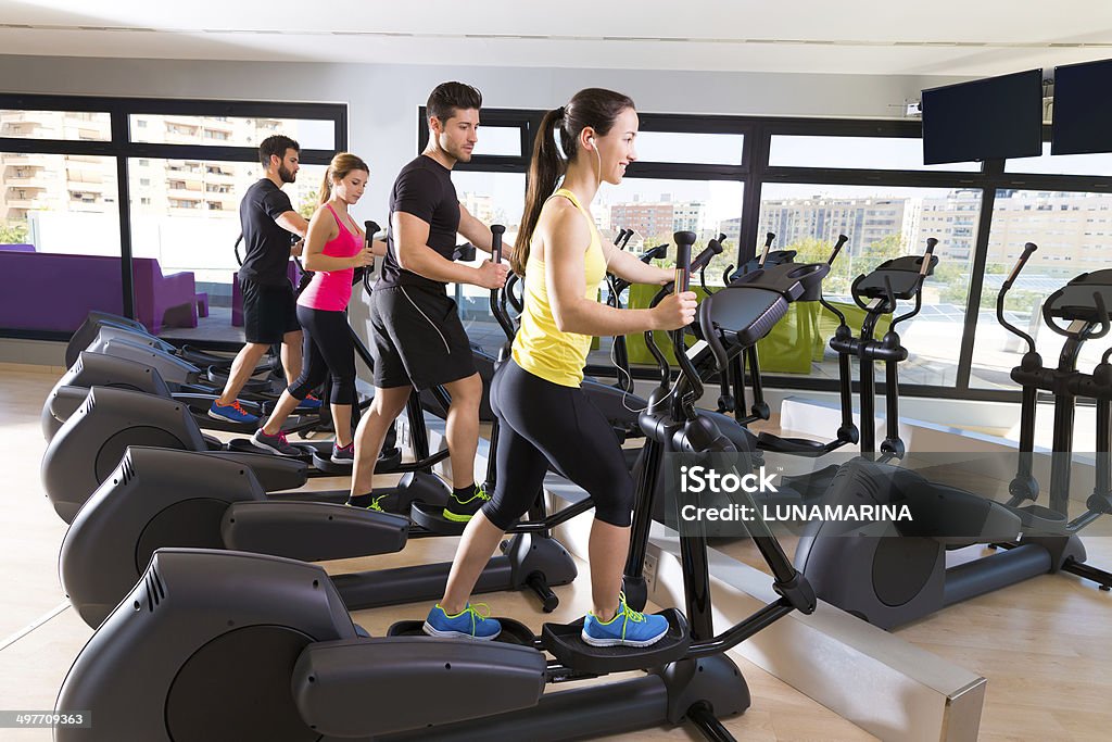 Aerobics elliptical walker trainer group at gym Aerobics elliptical walker trainer group at fitness gym workout Activity Stock Photo