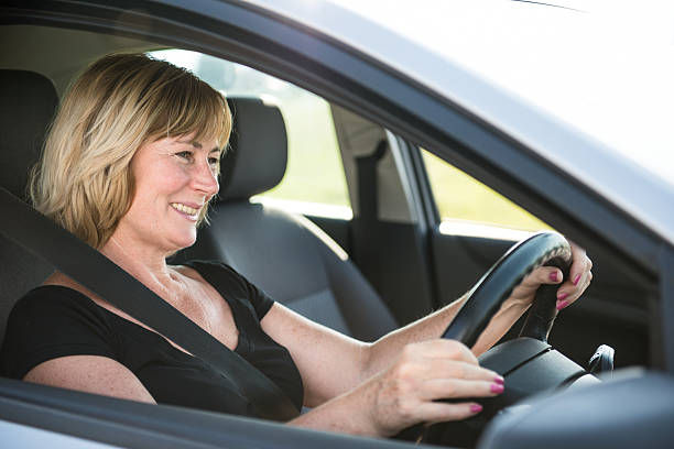 istock Senior woman driving car 497710211