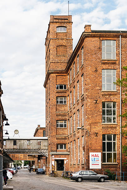 Baumwollspinnerei Leipzig, Germany Leipzig, Germany - May 8, 2015: Baumwollspinnerei in Leipzig, Germany. The so-called Baumwollspinnerei (Cotton Mill) is an industrial site in the western part of Leipzig, in Lindenau, which is used today by art galleries, studios and restaurants. cotton mill stock pictures, royalty-free photos & images