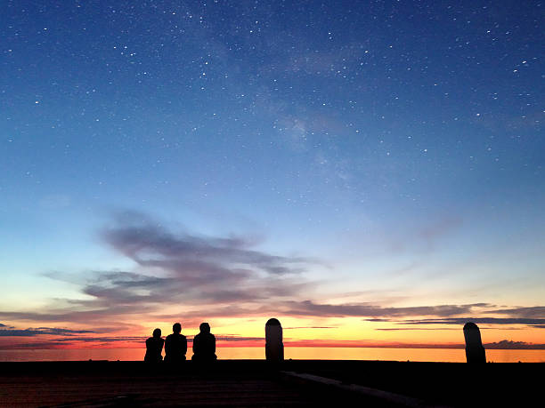 istock Silhouettes of three people at sunset 497712279