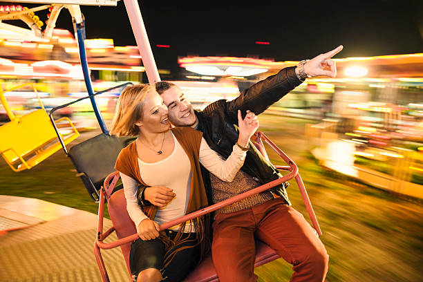istock Young smilinf couple having a ride on a ferris wheel 497712418