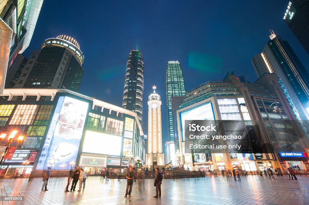 Business center of Chongqing(Jiefangbei) at night Chongqing,China - April 8, 2014: People walking in Business center of Chongqing at night,Chongqing is a major city in the west south of China.Now it developed into an international city.Jiefangbei is Business center of Chongqing, there are lots of Skyscraper. City Stock Photo