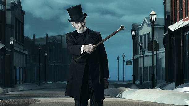 istock Dickens Scrooge Man in Old Winter Street. Pointing with Cane. 497713228