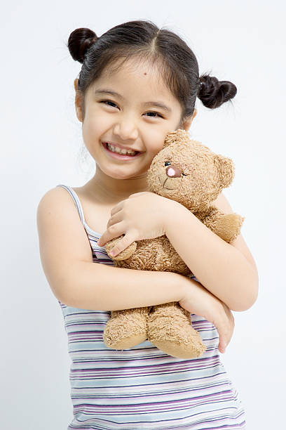 istock Pretty girl playing with bear doll 497713533