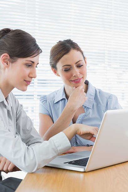 istock Two businesswomen working on laptop together 497713649