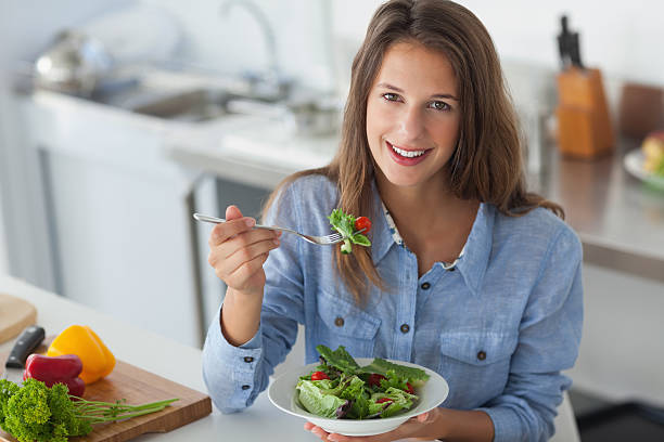 istock Pretty woman eating a salad 497714267