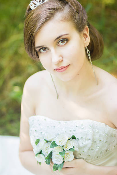 istock Portrait of a beautiful young bride in nature 497714327