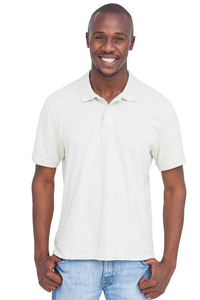 Smiling man with thumbs in pocket Smiling man with thumbs in pocket on a white background polo shirt stock pictures, royalty-free photos & images