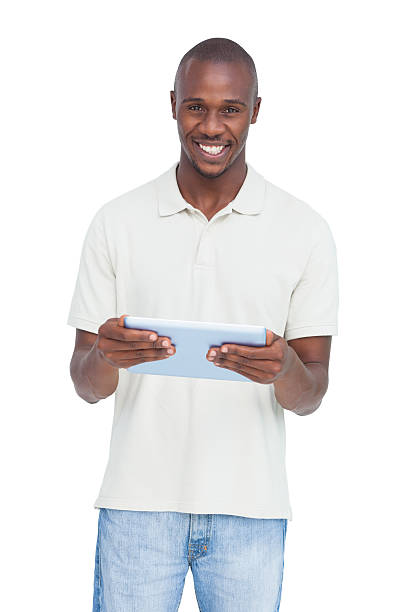 hombre feliz sosteniendo un tablet pc - polo shirt african ethnicity men african descent fotografías e imágenes de stock