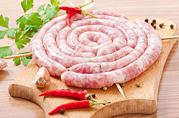 istock Fresh raw sausage on wooden background 497715149