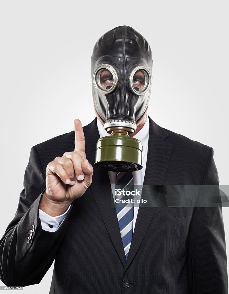 Men in a suit with gas mask Businessman in a suit wearing a gas mask Gas Mask Stock Photo