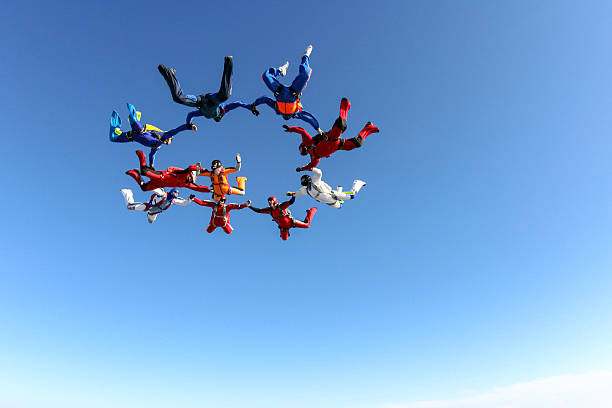 Skydiving photo. Building a group of paratroopers ring in free fall. arrangement stock pictures, royalty-free photos & images