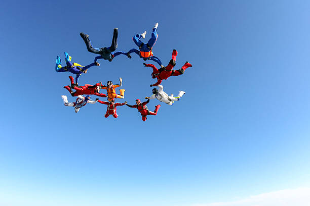 Skydiving photo. Building a group of paratroopers ring in free fall. extreme sports stock pictures, royalty-free photos & images