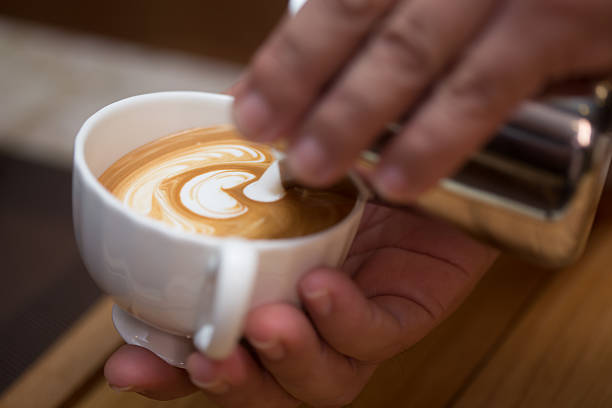 istock Charming young man enjoying aroma coffee in cafe 497739482