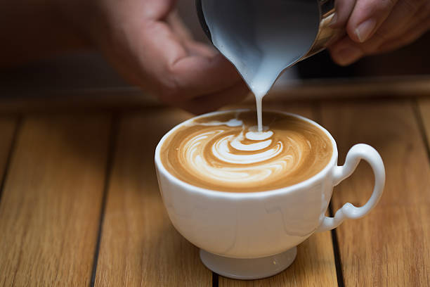 istock Charming young man enjoying aroma coffee in cafe 497740236
