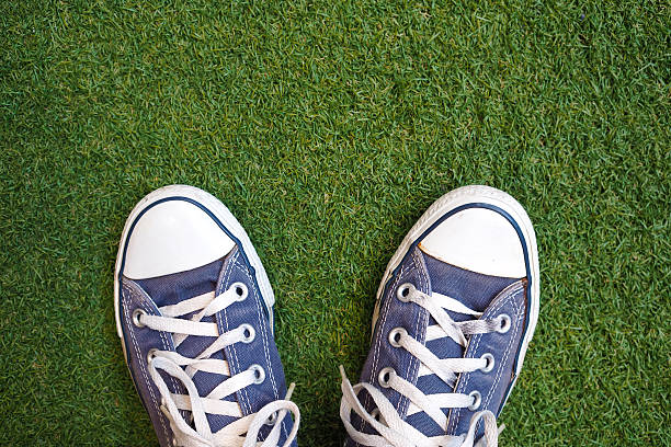 istock Blue sneaker shoes on grass. Top view. Vintage effect. 497741666
